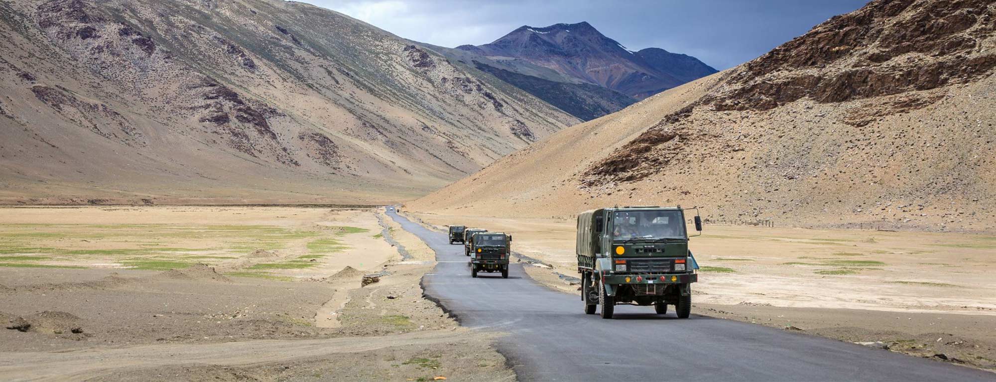 Military vehicles in remote barren landscape